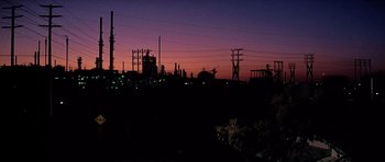 Movie still from “Scarface” (1983), directed by Brian De Palma – A view of an industrial area at night; Extreme Wide shot, Low angle