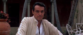 Movie still from “Scarface” (1983), directed by Brian De Palma – A person wearing a shirt and jacket; Close Up shot, Low angle