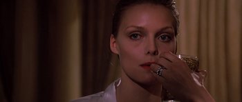 Movie still from “Scarface” (1983), directed by Brian De Palma – A beautiful woman with a finger in her mouth; Close Up shot, Low angle
