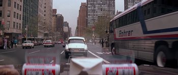 Movie still from “Scarface” (1983), directed by Brian De Palma – A view from a car window of a city street; Wide shot, High angle