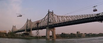 Movie still from “Scarface” (1983), directed by Brian De Palma – A large bridge with a crane on top of it; Extreme Wide shot, Low angle