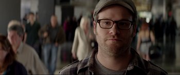 Movie still from “This Is the End” (2013), directed by Seth Rogen – A person wearing glasses and a hat; Close Up shot, Over the shoulder angle