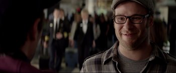 Movie still from “This Is the End” (2013), directed by Seth Rogen – A person wearing glasses and a hat; Close Up shot, Over the shoulder angle