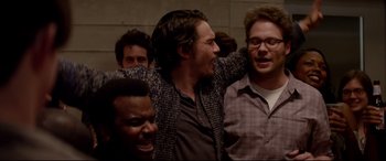 Movie still from “This Is the End” (2013), directed by Seth Rogen – A group of men standing next to each other in a room; Medium shot, Over the shoulder angle