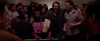 Movie still from “This Is the End” (2013), directed by Seth Rogen – A group of people standing next to each other in front of a keyboard; Medium shot, High angle