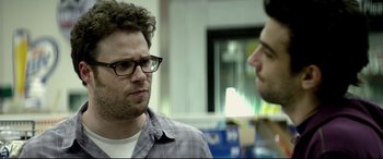 Movie still from “This Is the End” (2013), directed by Seth Rogen – A man with glasses is talking to another man; Close Up shot, Over the shoulder angle