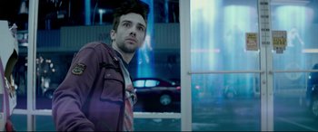Movie still from “This Is the End” (2013), directed by Seth Rogen – A man standing in front of a window in a city; Medium shot, Low angle