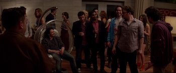 Movie still from “This Is the End” (2013), directed by Seth Rogen – A group of people standing in a room with drinks; Wide shot, High angle