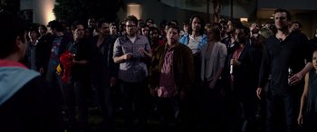 Movie still from “This Is the End” (2013), directed by Seth Rogen – A large group of people standing in the dark; Wide shot, High angle