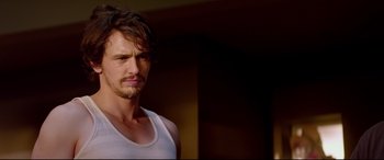 Movie still from “This Is the End” (2013), directed by Seth Rogen – A person wearing a white shirt; Close Up shot, Over the shoulder angle