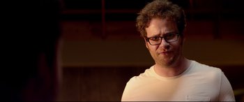 Movie still from “This Is the End” (2013), directed by Seth Rogen – A person wearing glasses and a white shirt; Close Up shot, Over the shoulder angle