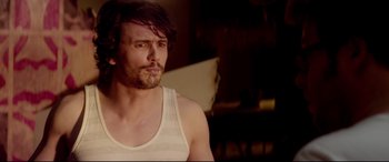 Movie still from “This Is the End” (2013), directed by Seth Rogen – A person wearing a tank top; Close Up shot, Over the shoulder angle