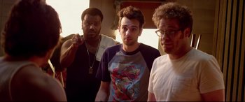 Movie still from “This Is the End” (2013), directed by Seth Rogen – A group of men standing next to each other in a room; Medium shot, Over the shoulder angle