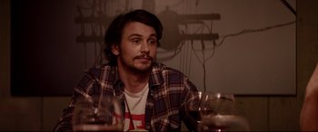 Movie still from “This Is the End” (2013), directed by Seth Rogen – A man sitting in front of a bunch of wine glasses; Close Up shot, Over the shoulder angle