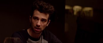 Movie still from “This Is the End” (2013), directed by Seth Rogen – A person sitting in front of a wall; Close Up shot, Over the shoulder angle