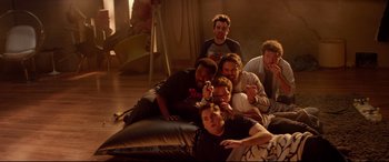 Movie still from “This Is the End” (2013), directed by Seth Rogen – A group of people sitting in a room together; Wide shot, High angle