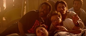 Movie still from “This Is the End” (2013), directed by Seth Rogen – A group of people that are posing for a picture; Close Up shot, Low angle