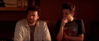 Movie still from “This Is the End” (2013), directed by Seth Rogen – A couple of men standing next to each other; Medium shot, Over the shoulder angle