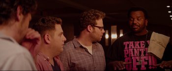 Movie still from “This Is the End” (2013), directed by Seth Rogen – A group of men standing next to each other in a room; Medium shot, Over the shoulder angle