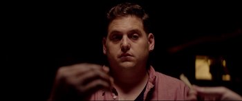 Movie still from “This Is the End” (2013), directed by Seth Rogen – A person holding a cell phone; Close Up shot, Over the shoulder angle