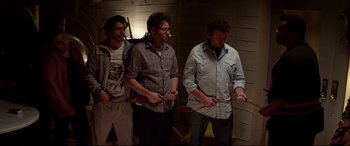 Movie still from “This Is the End” (2013), directed by Seth Rogen – A group of men standing next to each other holding wii remotes; Medium shot, High angle