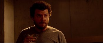 Movie still from “This Is the End” (2013), directed by Seth Rogen – A person holding a glass of wine; Close Up shot, Over the shoulder angle