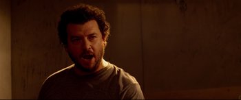 Movie still from “This Is the End” (2013), directed by Seth Rogen – A person with curly hair and a beard; Close Up shot, Over the shoulder angle