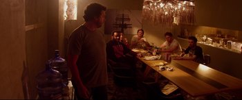 Movie still from “This Is the End” (2013), directed by Seth Rogen – A group of people sitting at a table with plates of food; Medium shot, High angle