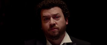 Movie still from “This Is the End” (2013), directed by Seth Rogen – A person wearing a suit and tie; Close Up shot, Low angle