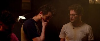 Movie still from “This Is the End” (2013), directed by Seth Rogen – Two men are standing in a room and one of them has his hand to his face; Close Up shot, Over the shoulder angle