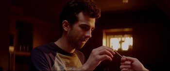 Movie still from “This Is the End” (2013), directed by Seth Rogen – A man is smoking a cigarette in a room; Close Up shot, Over the shoulder angle