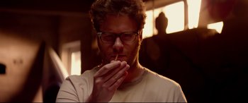Movie still from “This Is the End” (2013), directed by Seth Rogen – A person holding a cigarette in his mouth; Close Up shot, Low angle