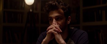 Movie still from “This Is the End” (2013), directed by Seth Rogen – A man with his hands over his mouth; Close Up shot, Over the shoulder angle