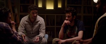 Movie still from “This Is the End” (2013), directed by Seth Rogen – Two young men sitting in a living room next to each other; Medium shot, Over the shoulder angle