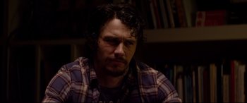 Movie still from “This Is the End” (2013), directed by Seth Rogen – A person wearing a plaid shirt; Close Up shot, Over the shoulder angle