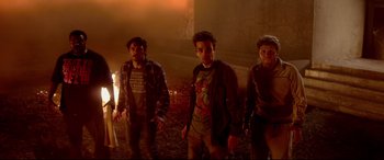 Movie still from “This Is the End” (2013), directed by Seth Rogen – A group of young men standing next to each other in the dark; Medium shot, Low angle