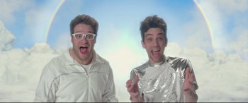 Movie still from “This Is the End” (2013), directed by Seth Rogen – Two men are posing for a picture together; Medium shot, Low angle