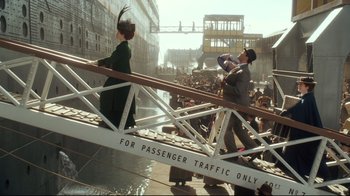 Movie still from “Titanic” (1997), directed by James Cameron – A man and a woman walking across a bridge; Extreme Wide shot, Low angle