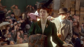 Movie still from “Titanic” (1997), directed by James Cameron – A woman in a green dress and a hat; Medium shot, Low angle