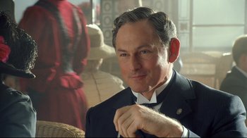 Movie still from “Titanic” (1997), directed by James Cameron – A person wearing a suit and tie; Close Up shot, Over the shoulder angle