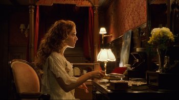 Movie still from “Titanic” (1997), directed by James Cameron – A woman sitting in front of a computer monitor; Medium shot, Low angle