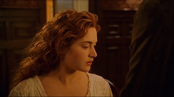 Movie still from “Titanic” (1997), directed by James Cameron – A person with curly hair; Close Up shot, Over the shoulder angle