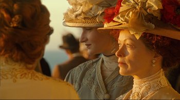 Movie still from “Titanic” (1997), directed by James Cameron – Two women wearing hats and looking at the camera; Close Up shot, Low angle
