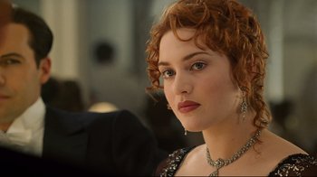 Movie still from “Titanic” (1997), directed by James Cameron – A person with curly red hair; Close Up shot, Over the shoulder angle