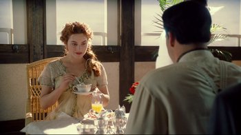 Movie still from “Titanic” (1997), directed by James Cameron – A man and a woman are sitting at a table; Medium shot, Over the shoulder angle