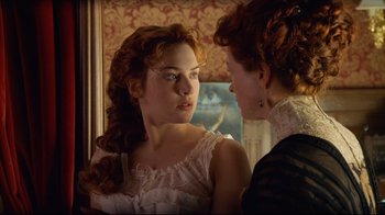 Movie still from “Titanic” (1997), directed by James Cameron – Two women are looking at one another in a mirror; Close Up shot, Over the shoulder angle