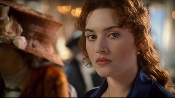 Movie still from “Titanic” (1997), directed by James Cameron – A person wearing a blue shirt; Close Up shot, Over the shoulder angle