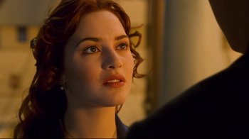 Movie still from “Titanic” (1997), directed by James Cameron – A woman's face as she looks into the distance; Close Up shot, Over the shoulder angle