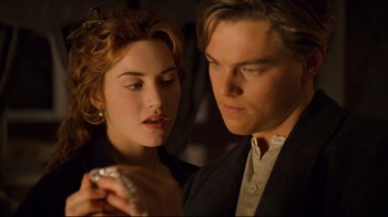 Movie still from “Titanic” (1997), directed by James Cameron – A man and a woman standing next to each other; Close Up shot, Low angle