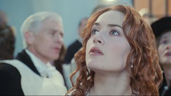 Movie still from “Titanic” (1997), directed by James Cameron – A person with long red curly hair; Close Up shot, Low angle